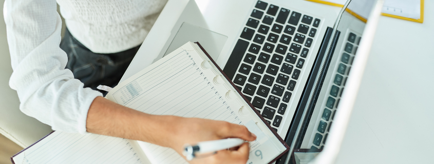 An image of a person writing down notes