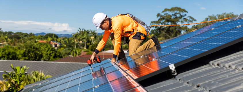 An image of a man on the roof working on solar panels